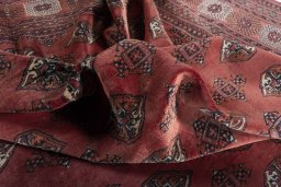 Corner detail of 2000s Baloch rug showing border pattern and Wool pile