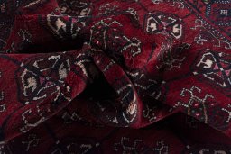 Corner detail of 2000s Baloch rug showing border pattern and Wool pile