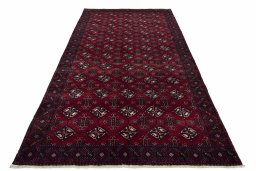 Surface texture of 2000s Baloch rug with natural Wool and intricate pattern
