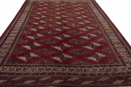 Surface texture of 1970s Baloch rug with natural Wool and intricate pattern