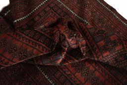Corner detail of 2000s Baloch rug showing border pattern and Wool pile