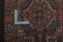 Corner detail of 2000s Baloch rug showing border pattern and Wool pile