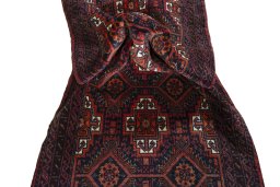 Corner detail of 2000s Baloch rug showing border pattern and Wool pile