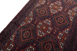 Backside of handmade 2000s Baloch rug showing knot structure and weave density