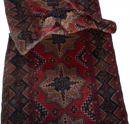 Corner detail of 2000s Baloch rug showing border pattern and Wool pile