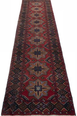 Surface texture of 2000s Baloch rug with natural Wool and intricate pattern