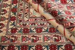 Corner detail of 1990s Baloch rug showing border pattern and Wool pile