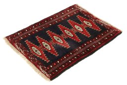 Corner detail of 1990s Baloch rug showing border pattern and Wool pile