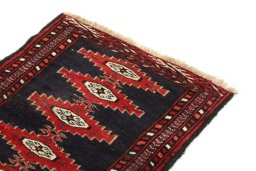 Surface texture of 1990s Baloch rug with natural Wool and intricate pattern