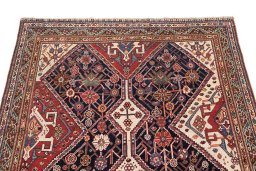 Surface texture of 1900s Ghashghai rug with natural Wool and intricate pattern