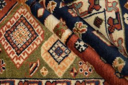 Corner detail of New Ghashghai rug showing border pattern and Wool pile