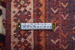 Surface texture of 2000s Ghashghai rug with natural Wool and intricate pattern