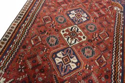 Backside of handmade 2000s Ghashghai rug showing knot structure and weave density