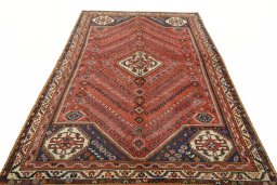 Surface texture of 2000s Ghashghai rug with natural Wool and intricate pattern