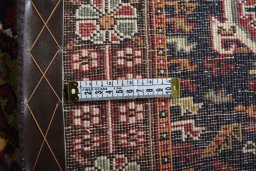 Surface texture of 2000s Ghashghai rug with natural Wool and intricate pattern