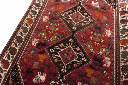 Backside of handmade 2000s Ghashghai rug showing knot structure and weave density