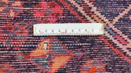 Backside of handmade 1950s Hamedan rug showing knot structure and weave density