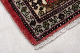 Backside of handmade New Hamedan rug showing knot structure and weave density