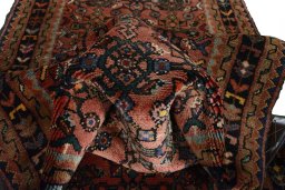 Corner detail of 2000s Hamedan rug showing border pattern and Wool pile