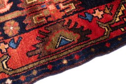 Backside of handmade 1970s Hamedan rug showing knot structure and weave density