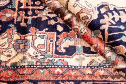 Corner detail of 1980s Hamedan rug showing border pattern and Wool pile