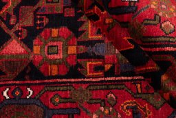 Corner detail of 1975s Hamedan rug showing border pattern and Wool pile