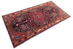 Corner detail of 1975s Hamedan rug showing border pattern and Wool pile