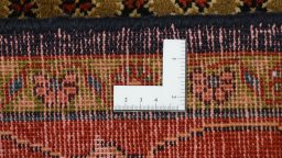 Corner detail of 2000s Hamedan rug showing border pattern and Wool pile