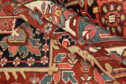 Full view of 1930s Heriz rug from Iran / Persia, 377 × 255 cm in Dark red tones