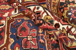 Full view of 1940s Heriz rug from Iran / Persia, 388 × 327 cm in Dark red tones