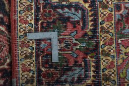 Backside of handmade 1930s Heriz rug showing knot structure and weave density
