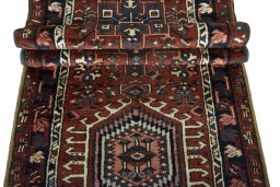 Full view of 1930s Heriz rug from Iran / Persia, 319 × 81 cm in Red tones