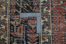 Backside of handmade 1930s Heriz rug showing knot structure and weave density