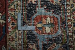 Backside of handmade 1930s Heriz rug showing knot structure and weave density