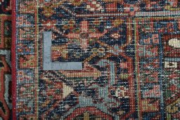 Backside of handmade 1930s Heriz rug showing knot structure and weave density