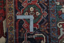 Backside of handmade 1930s Heriz rug showing knot structure and weave density