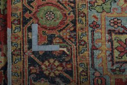 Backside of handmade 1930s Heriz rug showing knot structure and weave density