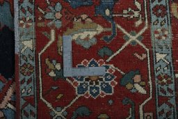 Backside of handmade 1930s Heriz rug showing knot structure and weave density