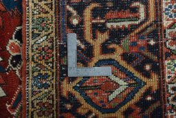 Backside of handmade 1930s Heriz rug showing knot structure and weave density