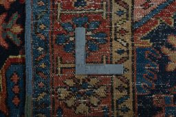 Backside of handmade 1930s Heriz rug showing knot structure and weave density