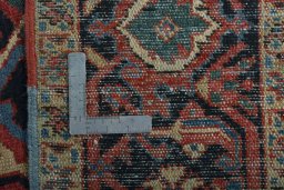 Backside of handmade 1930s Heriz rug showing knot structure and weave density