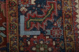 Backside of handmade 1930s Heriz rug showing knot structure and weave density