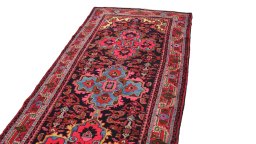 Surface texture of 1920s Malayer rug with natural Wool and intricate pattern