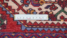 Backside of handmade 1970s Malayer rug showing knot structure and weave density