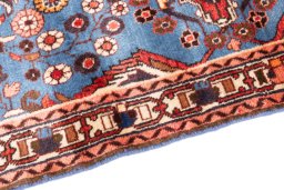 Backside of handmade 1999s Malayer rug showing knot structure and weave density