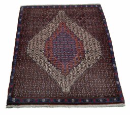 Backside of handmade New Senneh rug showing knot structure and weave density