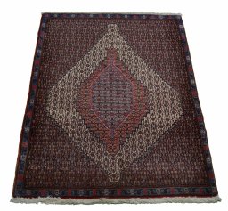 Backside of handmade New Senneh rug showing knot structure and weave density