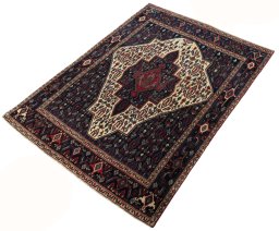 Corner detail of 1970s Senneh rug showing border pattern and Wool pile