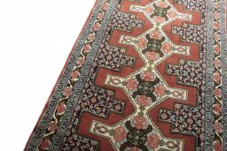 Backside of handmade 2000s Senneh rug showing knot structure and weave density