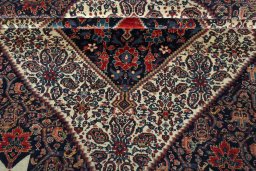 Corner detail of 1930s Senneh rug showing border pattern and Wool pile